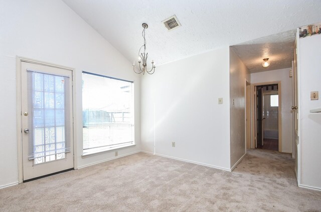 1478 Willow Wisp Dr, Missouri City, TX 77489 - empty room featuring carpet, plenty of natural light, a textured ceiling, a chandelier, and vaulted ceiling