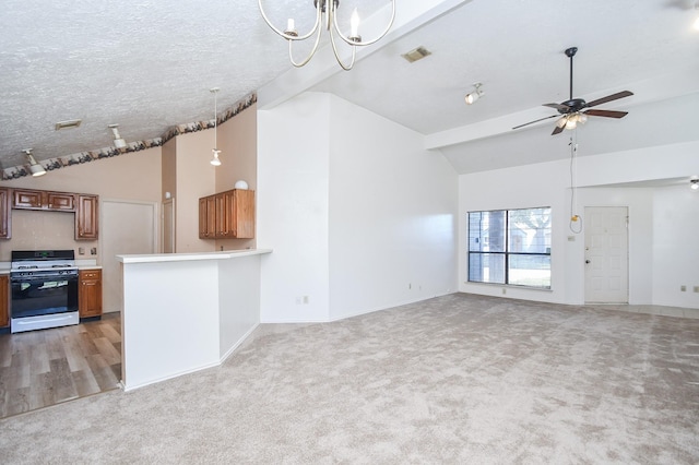 1478 Willow Wisp Dr, Missouri City, TX 77489 - unfurnished living room featuring vaulted ceiling, light colored carpet, ceiling fan, a chandelier, and baseboards