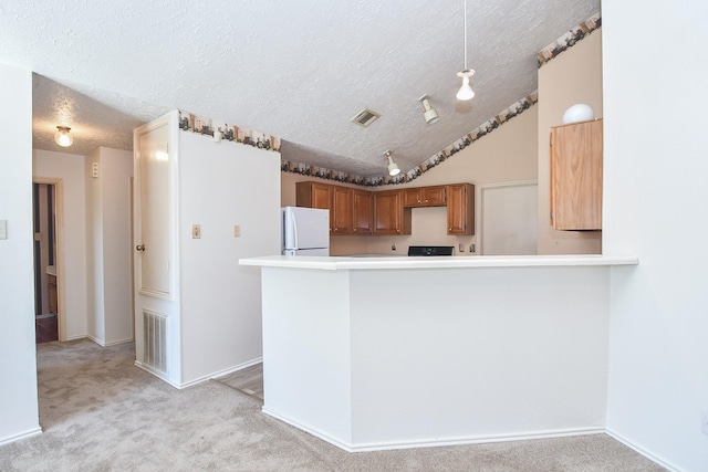 1478 Willow Wisp Dr, Missouri City, TX 77489 - kitchen with freestanding refrigerator, a textured ceiling, light colored carpet, brown cabinetry, and light countertops