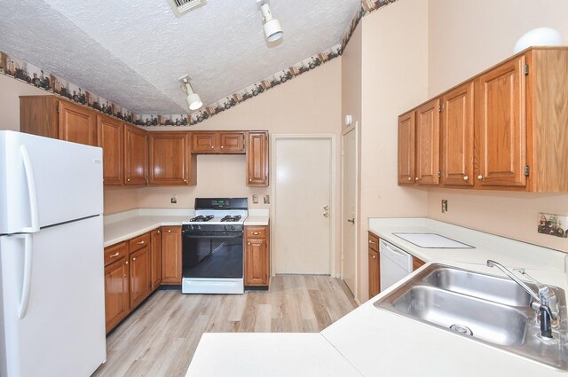 1478 Willow Wisp Dr, Missouri City, TX 77489 - kitchen featuring white appliances, a sink, a textured ceiling, light wood finished floors, and light countertops