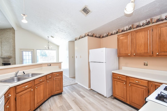 1478 Willow Wisp Dr, Missouri City, TX 77489 - kitchen with white appliances, a sink, light wood-style floors, brown cabinets, and lofted ceiling