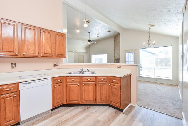 1478 Willow Wisp Dr, Missouri City, TX 77489 - kitchen featuring dishwasher, a sink, a peninsula, vaulted ceiling, and light wood-style floors