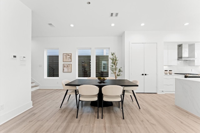 dining space with light wood-type flooring