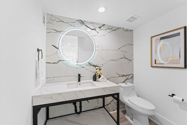 bathroom featuring sink and toilet