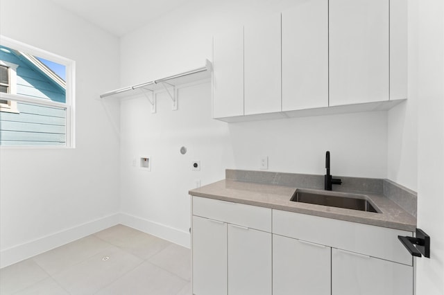 clothes washing area featuring cabinets, hookup for a washing machine, sink, and electric dryer hookup