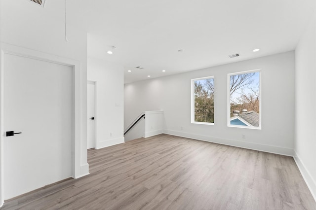 unfurnished room with light wood-type flooring