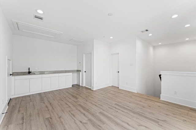 empty room with sink and light hardwood / wood-style floors