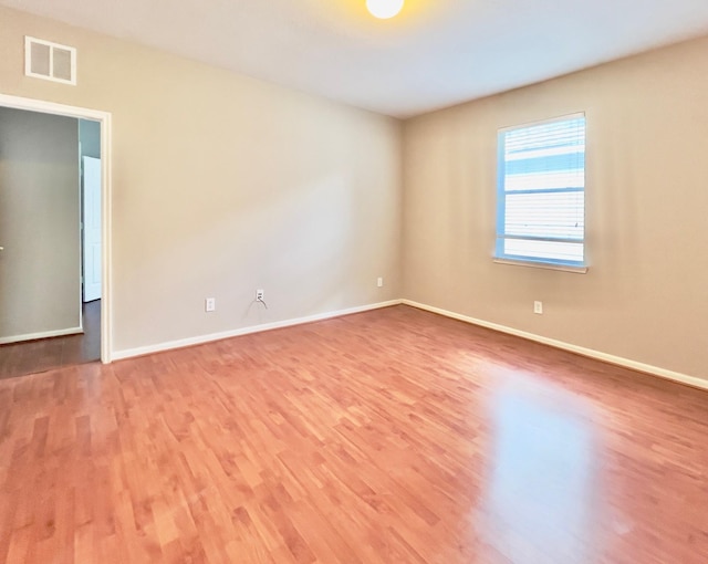 spare room with hardwood / wood-style flooring