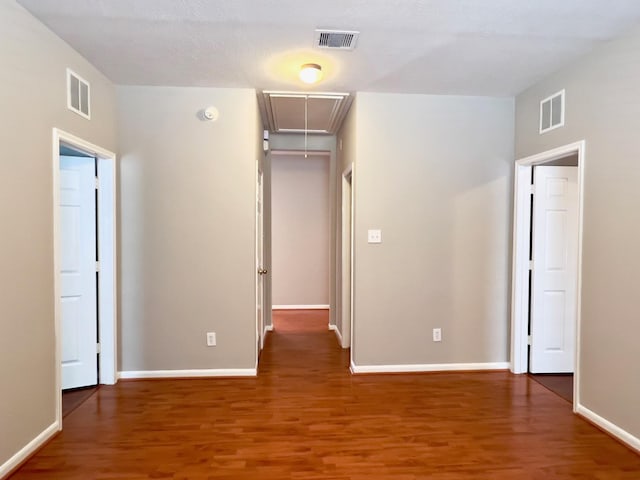 unfurnished bedroom with dark hardwood / wood-style flooring