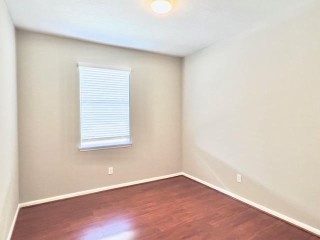 unfurnished room featuring dark hardwood / wood-style floors