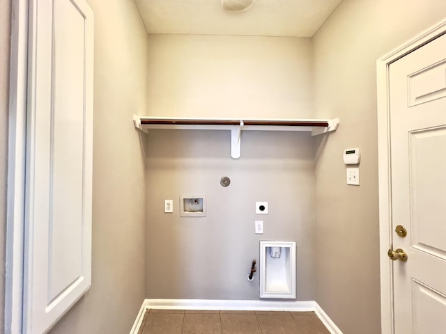 clothes washing area with electric dryer hookup, hookup for a washing machine, hookup for a gas dryer, and tile patterned flooring