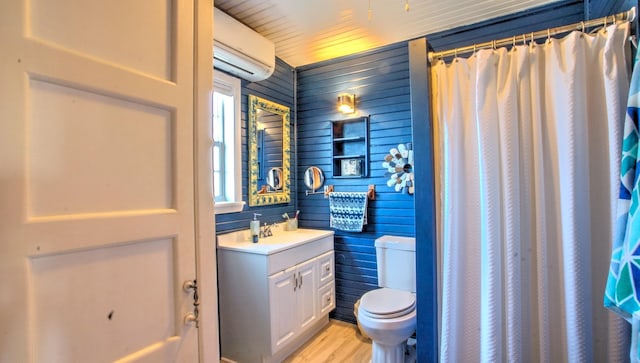 bathroom featuring an AC wall unit, wood-type flooring, vanity, walk in shower, and toilet