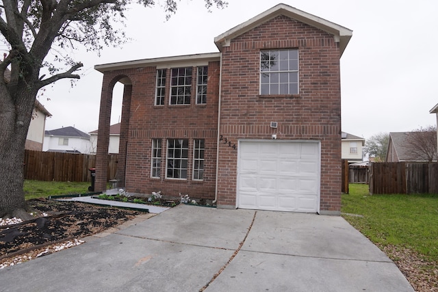 traditional-style home with brick siding, concrete driveway, an attached garage, fence, and a front yard