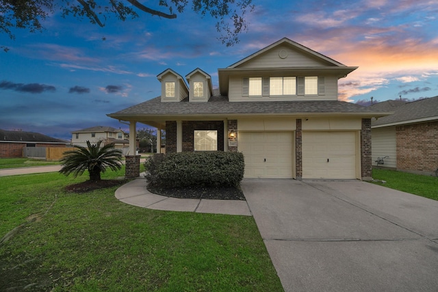 view of front of property featuring a garage and a yard