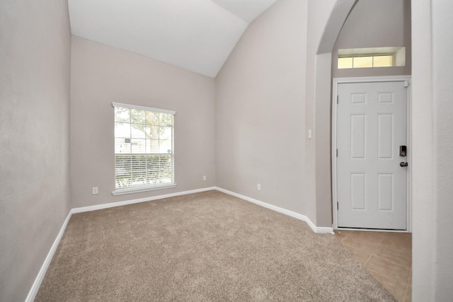 interior space with light carpet and lofted ceiling