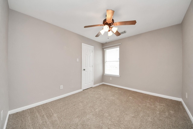 spare room with carpet floors and ceiling fan