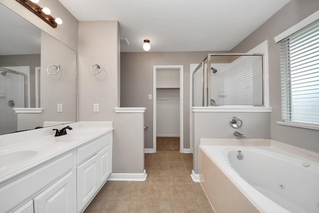 bathroom featuring tile patterned flooring, vanity, and shower with separate bathtub