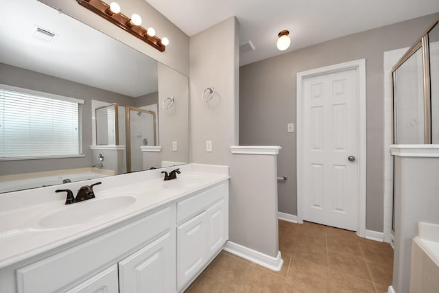 bathroom featuring shower with separate bathtub, tile patterned floors, and vanity