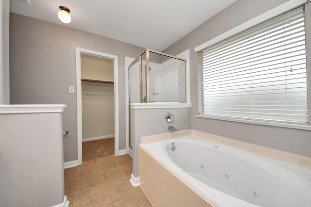 bathroom with tile patterned floors and plus walk in shower