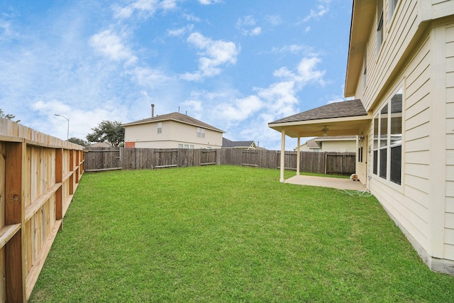 view of yard with a patio and ceiling fan