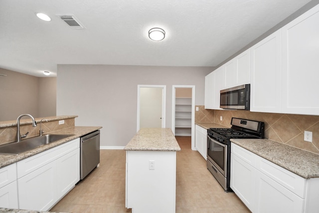 kitchen with white cabinetry, sink, an island with sink, and appliances with stainless steel finishes