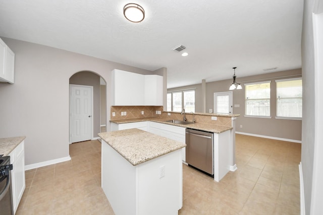 kitchen featuring a kitchen island, pendant lighting, white cabinetry, sink, and stainless steel dishwasher