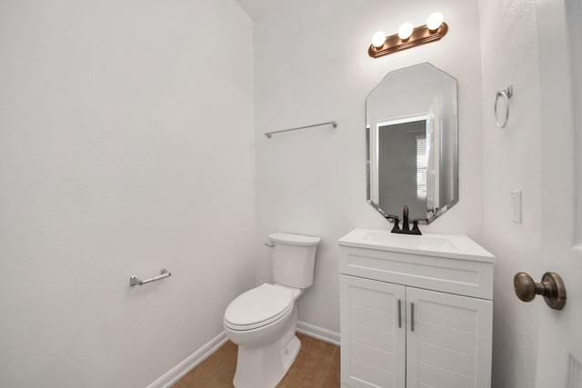 bathroom with tile patterned flooring, vanity, and toilet