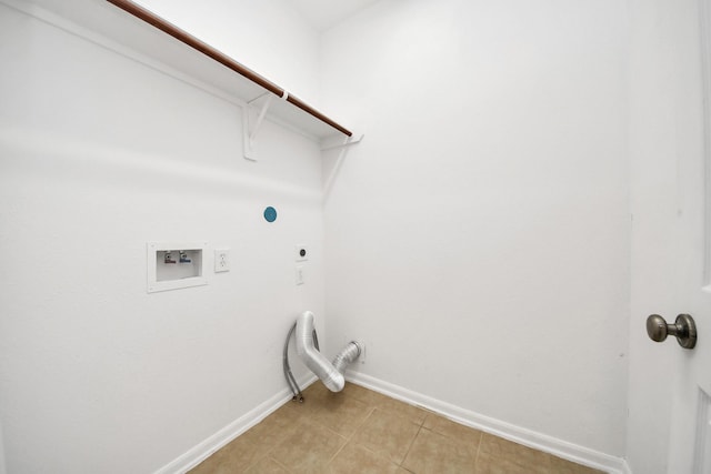 laundry area with gas dryer hookup, washer hookup, hookup for an electric dryer, and light tile patterned floors