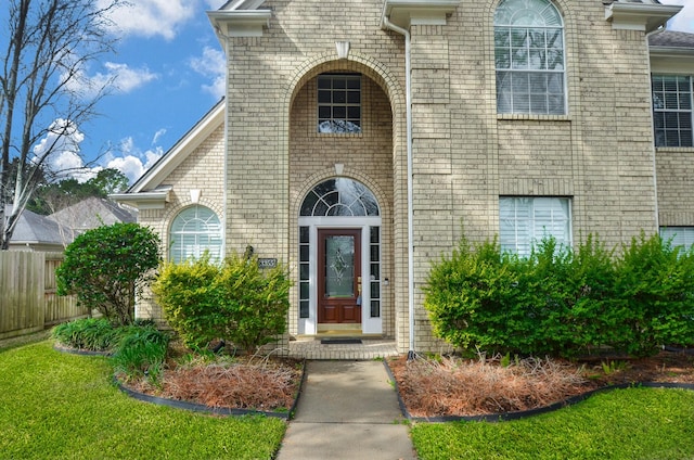 entrance to property with a lawn