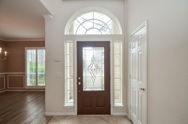 entrance foyer with a notable chandelier and ornamental molding