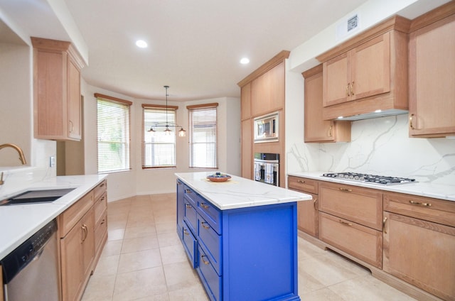 kitchen with pendant lighting, tasteful backsplash, sink, a center island, and stainless steel appliances