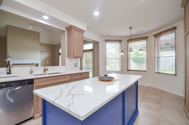 kitchen with a kitchen island, sink, hanging light fixtures, stainless steel dishwasher, and light brown cabinets