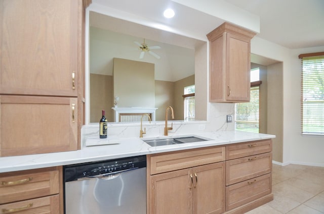 kitchen featuring sink, light tile patterned floors, vaulted ceiling, stainless steel dishwasher, and light brown cabinets