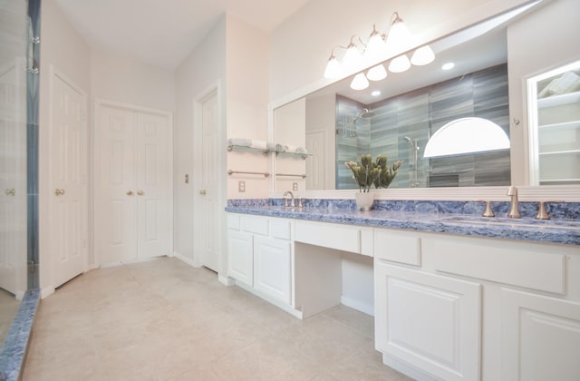 bathroom with vanity, an enclosed shower, and tile patterned flooring