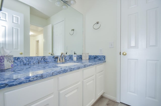 bathroom with hardwood / wood-style flooring and vanity