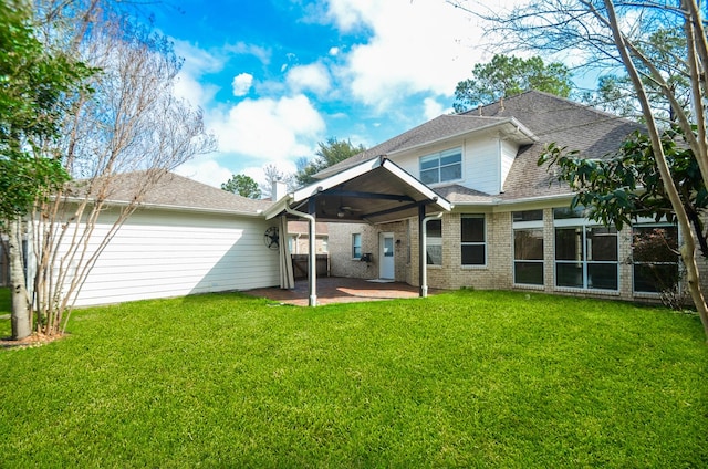 back of house with a yard and a patio