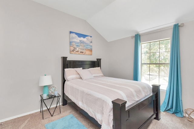 bedroom featuring light carpet and vaulted ceiling