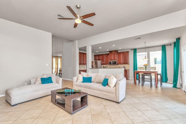 living room with ceiling fan and light tile patterned flooring