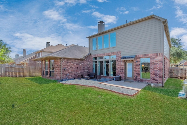 rear view of property featuring a patio and a yard