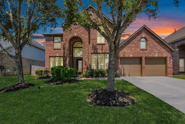 front facade with a garage and a yard