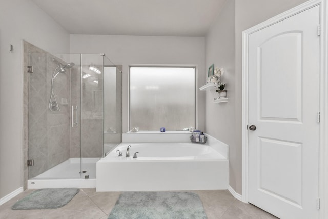 bathroom featuring plus walk in shower and tile patterned flooring