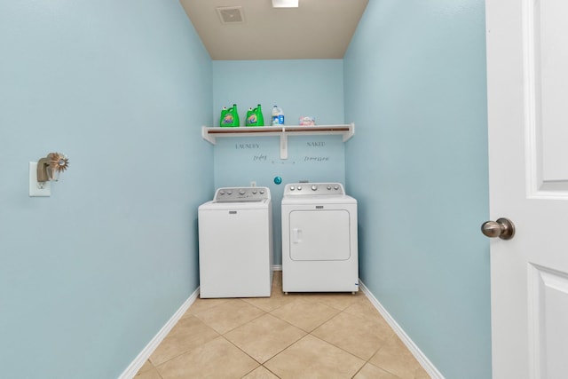 laundry room featuring light tile patterned flooring and washer and dryer