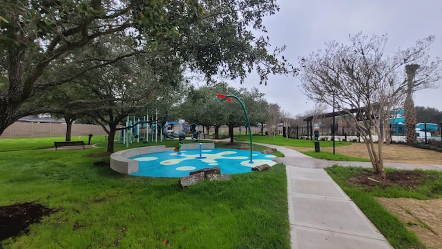 view of property's community featuring a playground and a yard