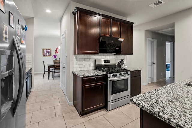 kitchen featuring decorative backsplash, ventilation hood, light stone countertops, and appliances with stainless steel finishes