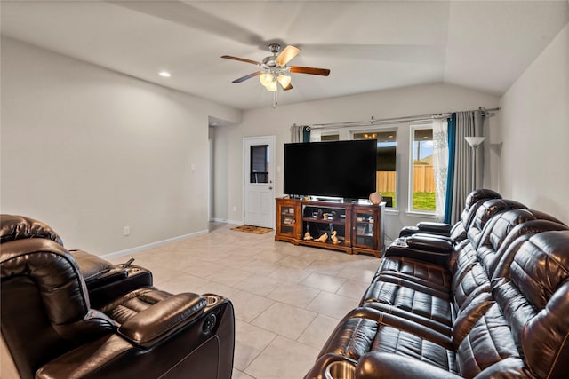 living room with ceiling fan, vaulted ceiling, and light tile patterned floors