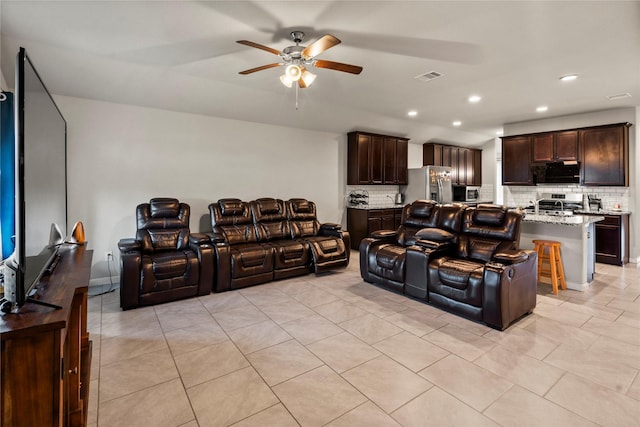 tiled living room with ceiling fan