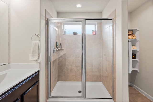 bathroom featuring vanity, tile patterned floors, and walk in shower