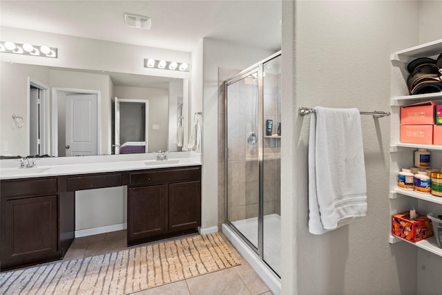 bathroom featuring vanity, a shower with shower door, and tile patterned floors