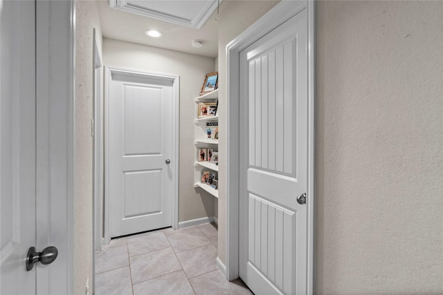 hall featuring light tile patterned floors