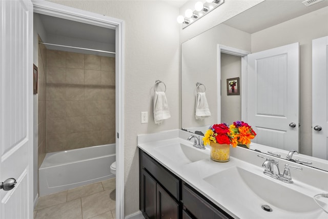 full bathroom with vanity, toilet, tiled shower / bath combo, and tile patterned flooring